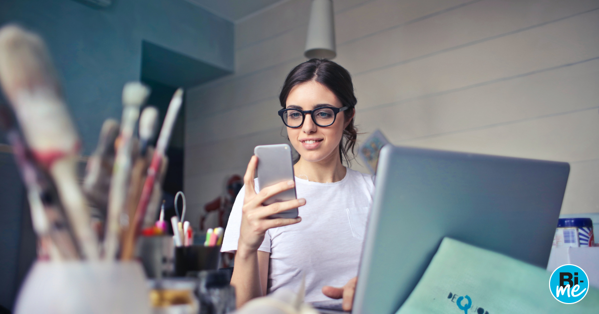 A young lady sitting at a table and looking at her cellphone