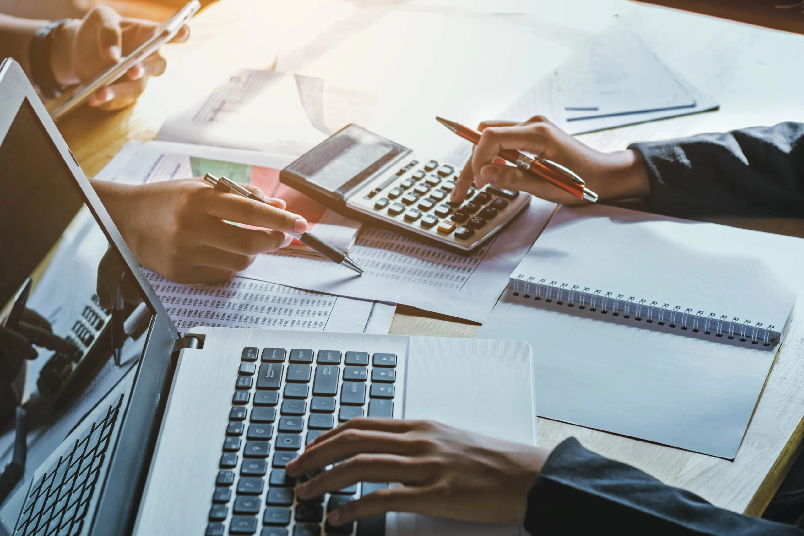 People calculating costs for Professional Indemnity Insurance